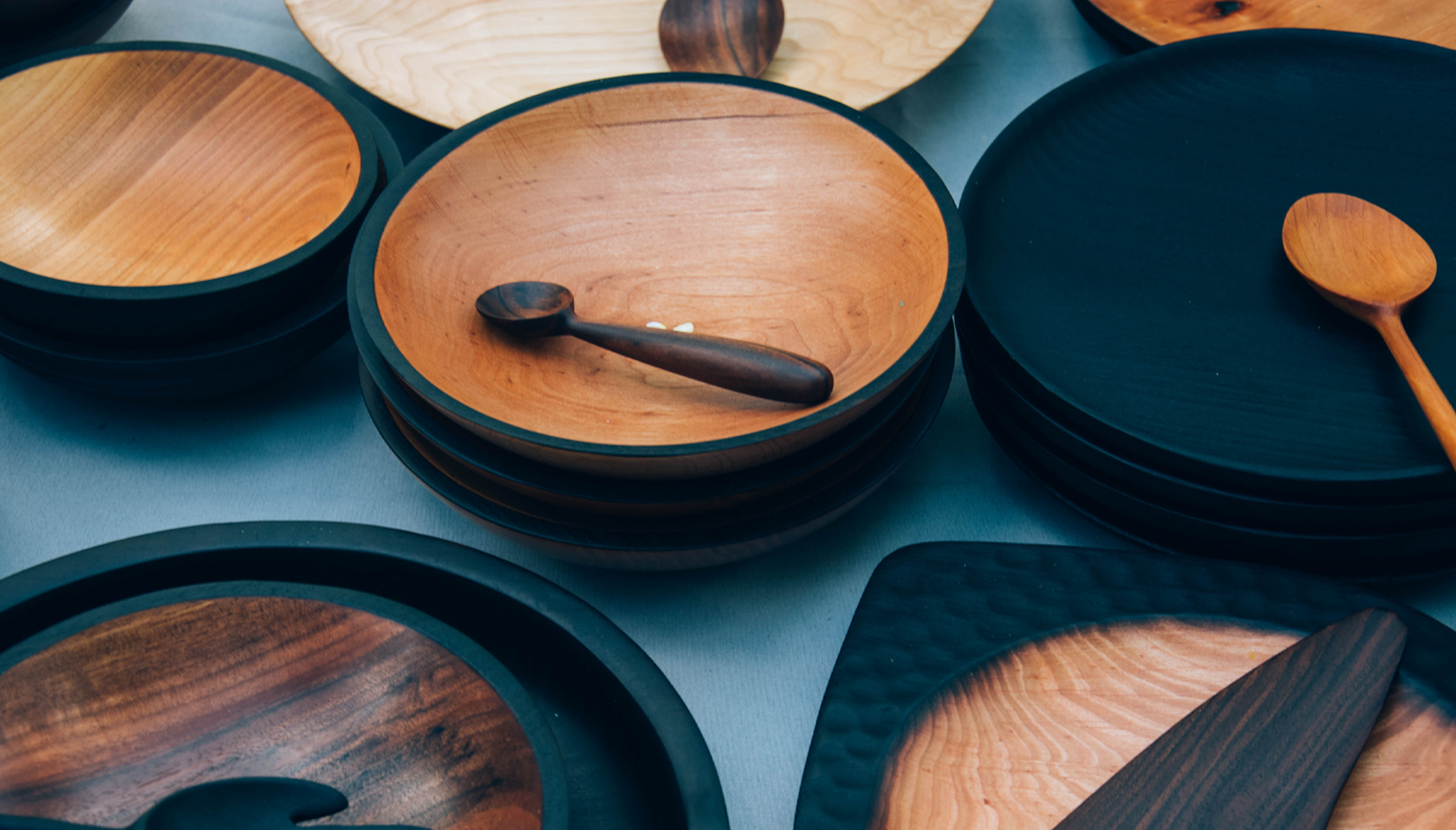 Turned wooden bowls and spoons with an oiled and waxed finish
